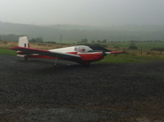 Motor glider on a foggy airfield